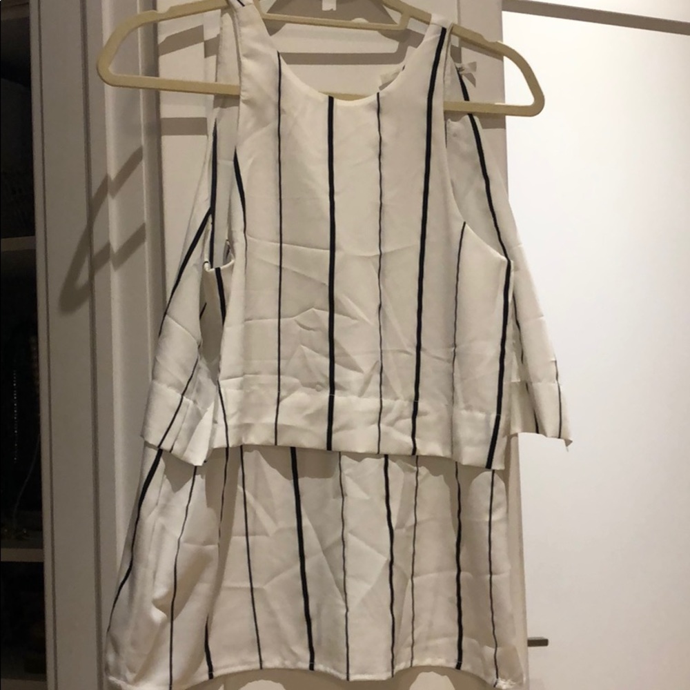 White shirt with black vertical stripes.